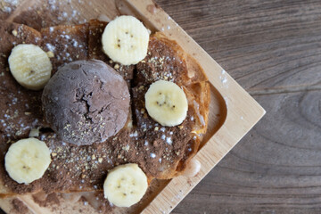 Banana split ice cream.A dessert with chocolate and banana.chocolate dessert on wooden plate
