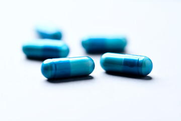 Amino acids capsules on paper background. Soft focus. Close up. Copy space.