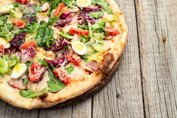 Italian pizza caesar with eggs salad chicken tomatoes and mozzarella photography. top view