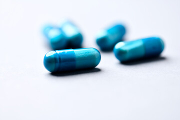 Amino acids capsules on paper background. Soft focus. Close up. Copy space.