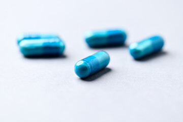 Amino acids capsules on paper background. Soft focus. Close up. Copy space.