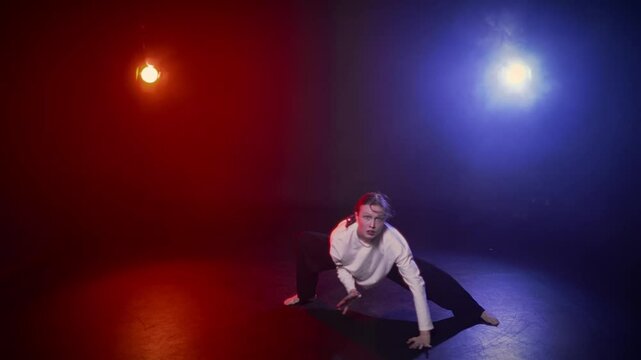 Be in motion, active hobby and passion, woman dancing alone in dance class. Happy young lady enjoying rhythmical music and moving in darkness, red and blue soffits illuminating female dancer figure