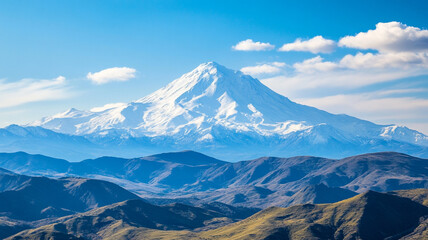 A majestic snow-capped mountain peak soars above a breathtaking winter landscape