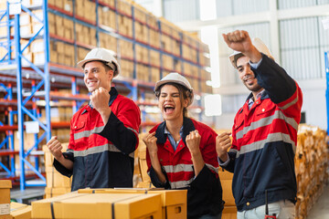 Warehouse team of industrial workers in red uniforms and safety helmets standing smiling teamwork...