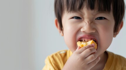 The image depicts a young child enthusiastically eating a piece Of food.
