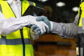 Fototapeta premium Close up technician engineer wearing and adjust protective safety glove. Safety equipment for industry factory. Safety at work concept.