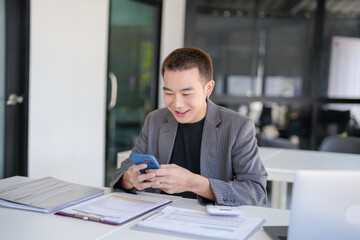 Asian Businessman with Smartphone working mobile devices cell telephone technology e-commerce smartphone business professional investor working new start up project