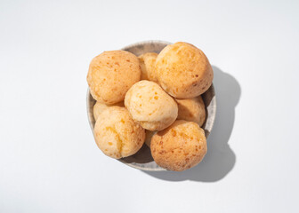 Cheese bread in the bowl, Brazilian pao de queijo mineiro, top view, white background