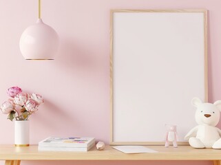 Mockup of a blank frame with wooden frame on a pink wall. with a light fixture hanging above a wooden table with a vase of pink flowers. books and two teddy bears