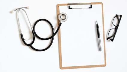 Top view of doctor office work with stethoscope, laptop and clipbroad with copy space for your text.