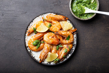  Fried shrimps with lemon and green in a plate, top view, copy space for text