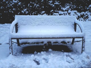 Snow-Covered Bench in Winter Landscape