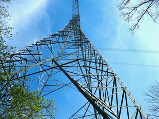 High Voltage Transmission Tower Against Blue Sky in Germany