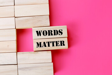 Words Matter symbol. Concept word Words Matter on wooden blocks. Beautiful pink background....