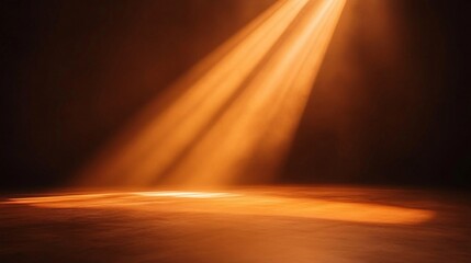 Orange beams of light extend from the stage against a dark backdrop, forming a vivid and concentrated spotlight effect.