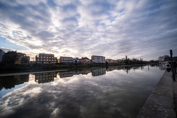 Ferrara waterway and navigable canal in Ferrara at sunset