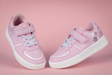 Pink child shoes on pink background. Children's shoes for girls