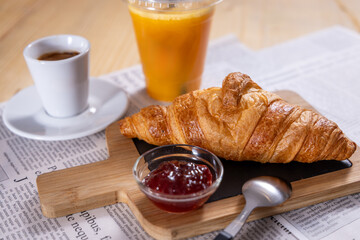 Breakfast with coffee and croissants, jam and orange juice