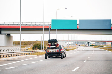 Vehicle with ATV trailer on overpass road