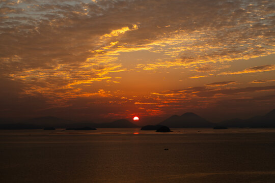 seascape with the sunrise over the islands - Powered by Adobe
