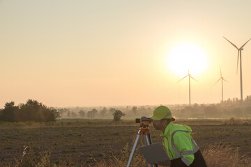 Survey Team Alternative energy for future. Engineers survey and checking wind turbines in sunset. Wind Turbine Renewable energy technology and sustainability.