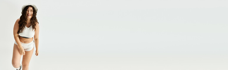 Obraz premium A young plus size woman poses joyfully in stylish underwear, radiating beauty and confidence.