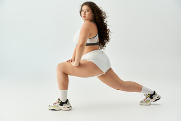 Beautiful plus size woman poses in trendy underwear, highlighting fashion and body positivity.
