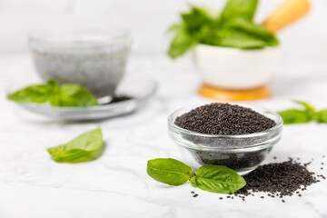 Basil seeds on textured wooden background. Close-up. Superfood. Ocimum basilicum. Organic basil seeds. selasih. Space for text. Copy space.