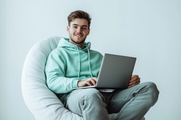 A person sitting at home or office using a laptop for work or personal purposes