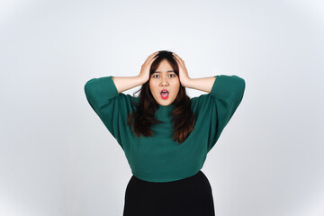 Hand on Head with shocked wow face expression Of Beautiful Asian Woman wearing Green Isolated On White Background