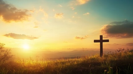 Scenic cross on hill with golden sunset landscape