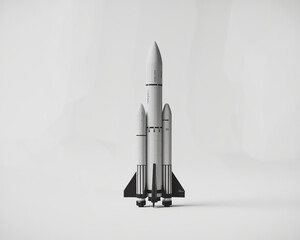 Obraz premium Model rocket launchpad showcasing a futuristic design with three-stage propulsion system in a minimalist setting
