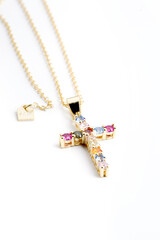 gold chain with cross pendant with colored stones