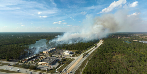 Aerial view of strong wildfire burning severely in North Port city, Florida. Natural disaster...