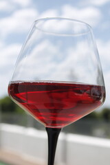 Close-up photo of a glass of red wine outdoors
