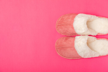 Soft slippers on a bright colored background, close-up. House slippers. Comfortable shoes for home. Foot care concept. Home comfort. Space for text. Copy space.