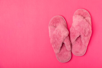 Soft slippers on a bright colored background, close-up. House slippers. Comfortable shoes for home. Foot care concept. Home comfort. Space for text. Copy space.