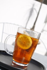Close-up of  a cup of tea with lemon outdoors