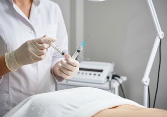 Women's cosmetology in the beauty salon, Beautiful lady at the beautician cabinet, woman receiving anti wrinkle injections on cheekbone