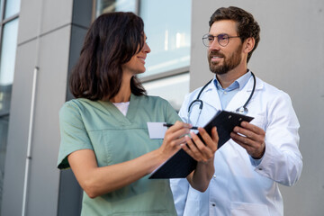 Two doctors discussing something and looking involved