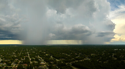 Landscape of dark ominous clouds forming on stormy sky during heavy thunderstorm over rural town...