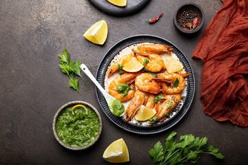  Fried shrimps with lemon and green sause in a plate, top view, copy space for text