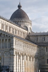 Pisa Cathedral. White marble facade of the cathedral.Pisan Romanesque style arcades with columns and arches. Italy
