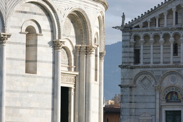 Romanesque architecture. Decorations on marble facades. Detail of the baptistery and the cathedral of Pisa with decorations in Romanesque style. Italy