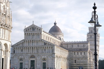 World heritage. Piazza dei Miracoli.Baptistery, Leaning Tower of Pisa and Pisa Cathedral in white marble stand out on a green lawn. Italy