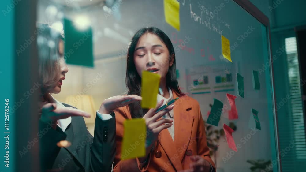 Poster two businesswomen engaging in a lively debate while brainstorming ideas, utilizing colorful sticky n