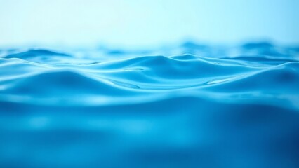 Tranquil blue ocean waves under clear sky at sunset