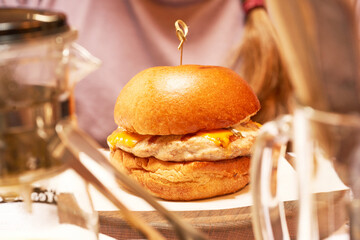 Close-up of a hamburger on the table. Side view.