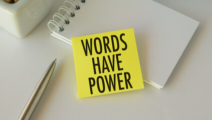 Words Have Power text on yellow sticky note with pen and notepad on white office desk, business concept