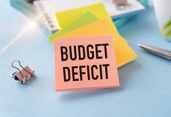 BUDGET DEFICIT text on paper on chart background